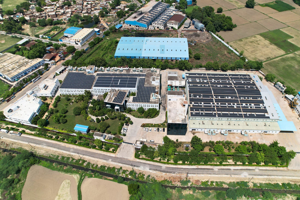 Aerial view of the AFPL campus, with rooftop solar, gardens and the farmland around it