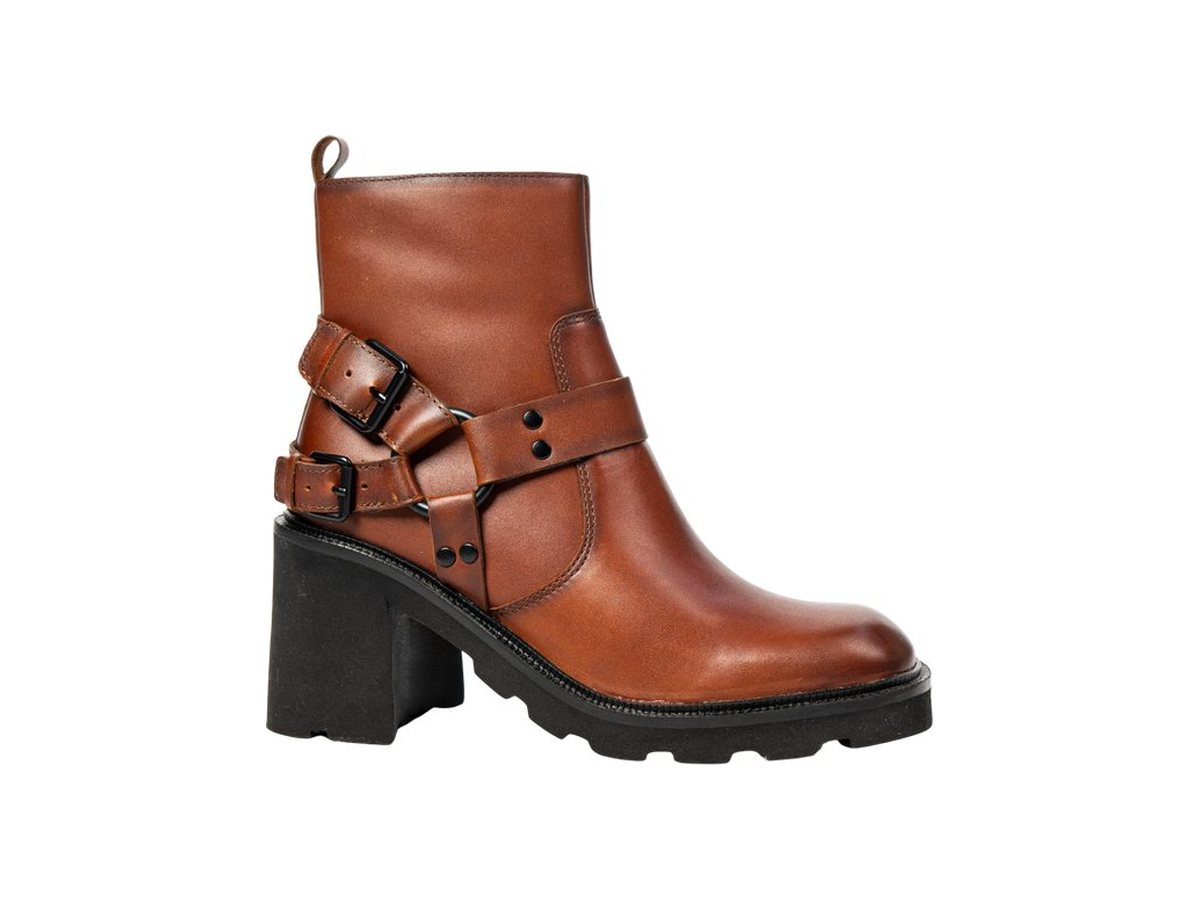 A cognac leather ankle boot with harness straps and a lug sole