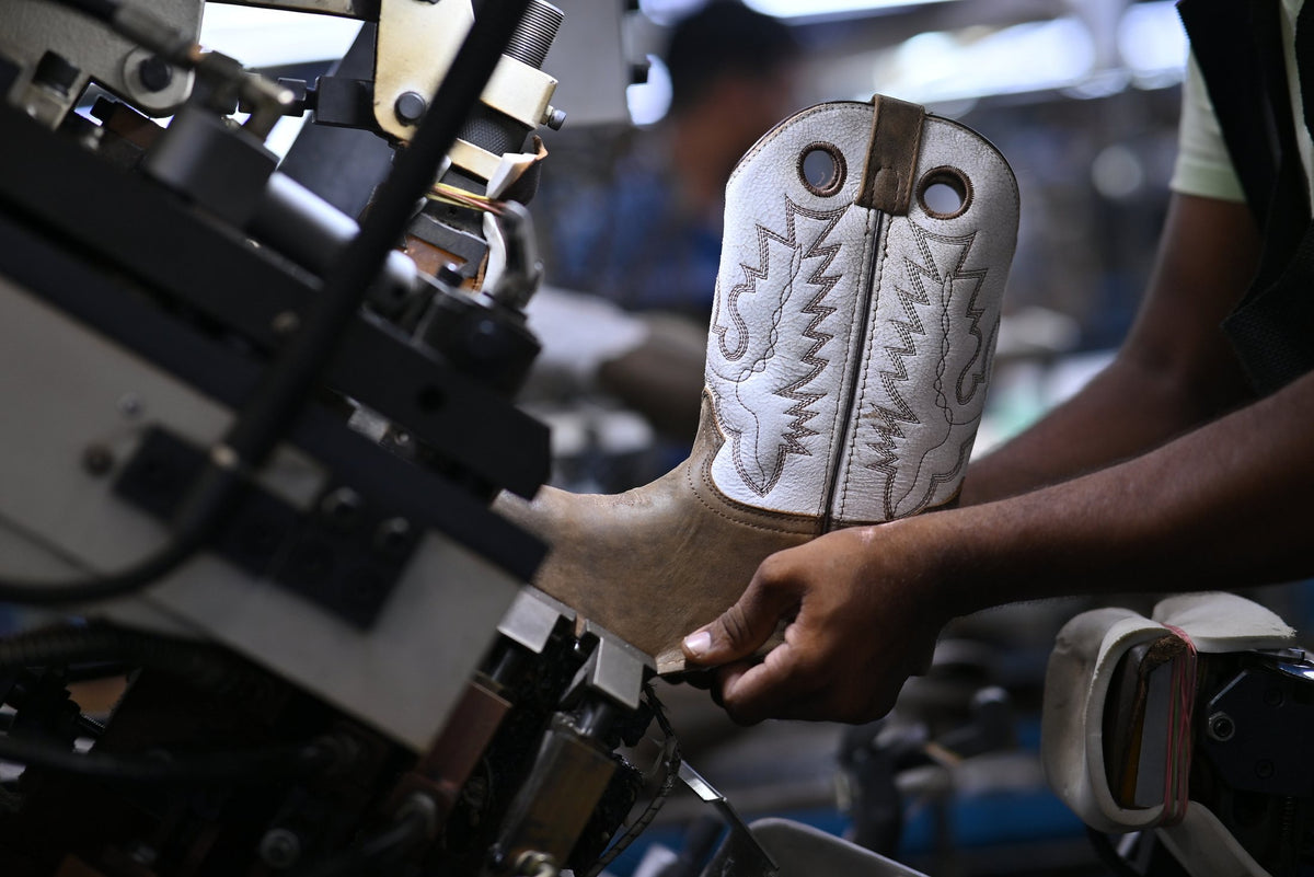 An embroidered white Western shaft on the line, held at a shaping machine
