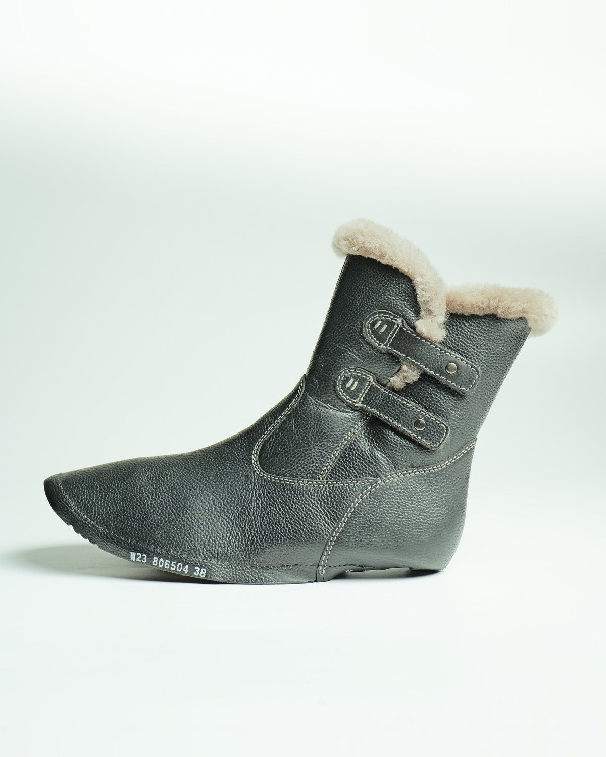 A lasted grey leather upper with a lamb fur collar and twin straps