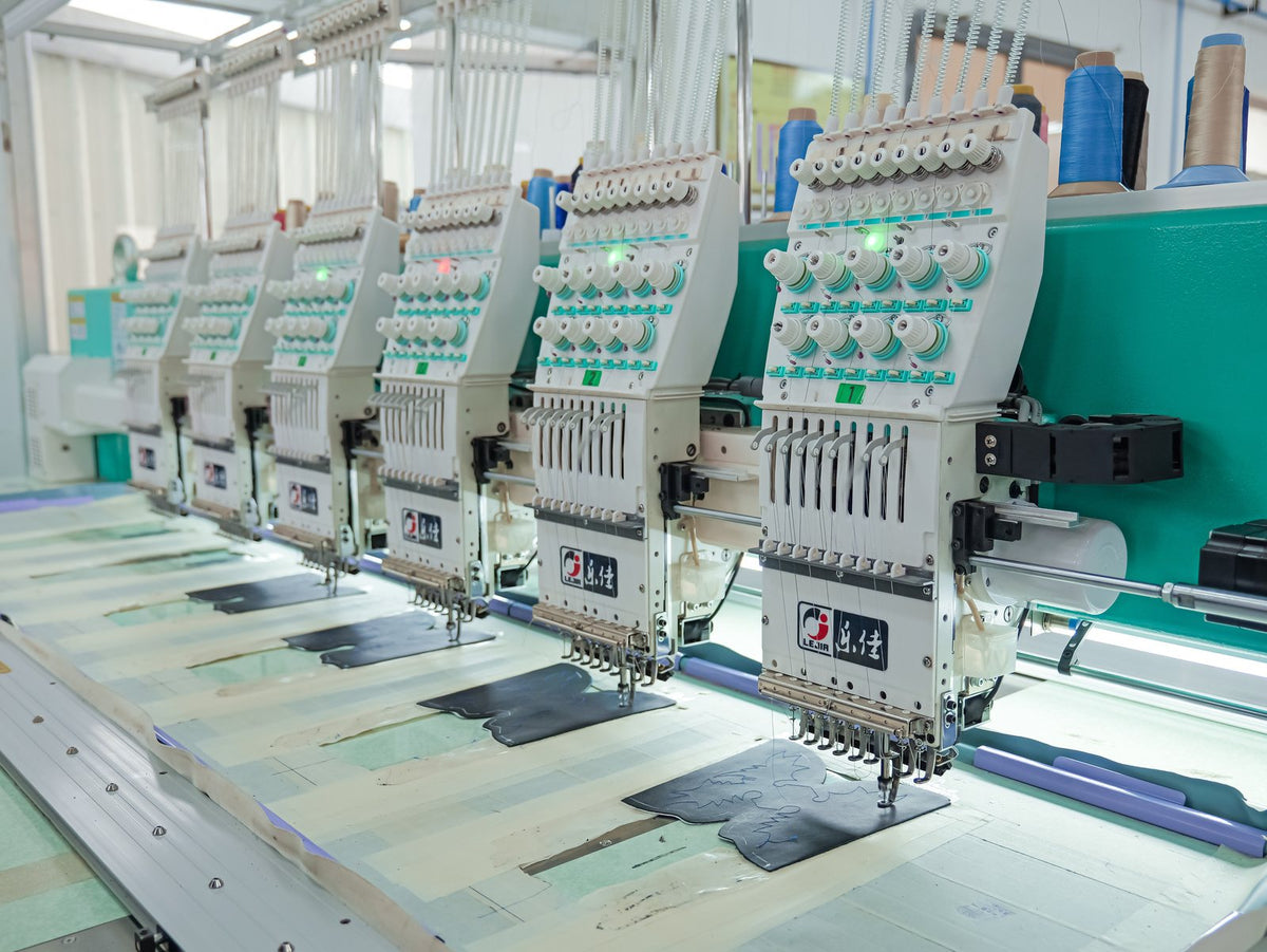 Multi-head embroidery machines working sample upper panels in the AFPL Product Creation Centre