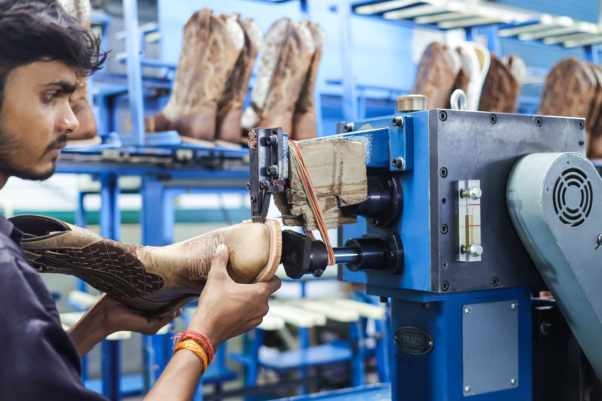 An operator working the sole of a lasted Western boot