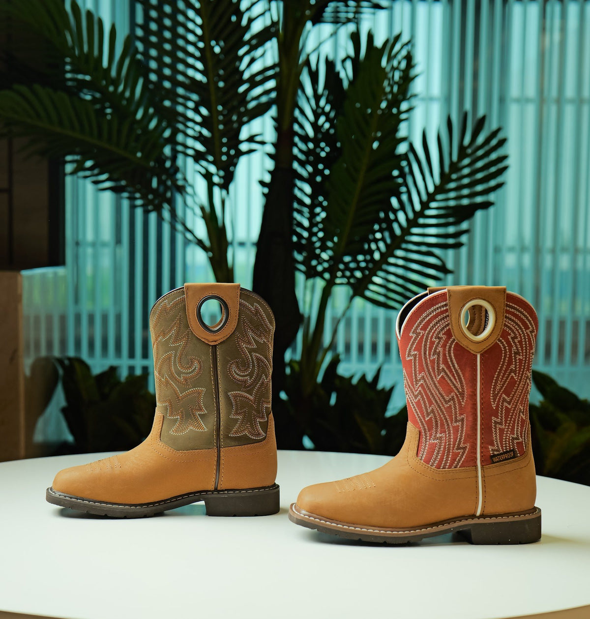 A pair of waterproof youth Western boots made by AFPL