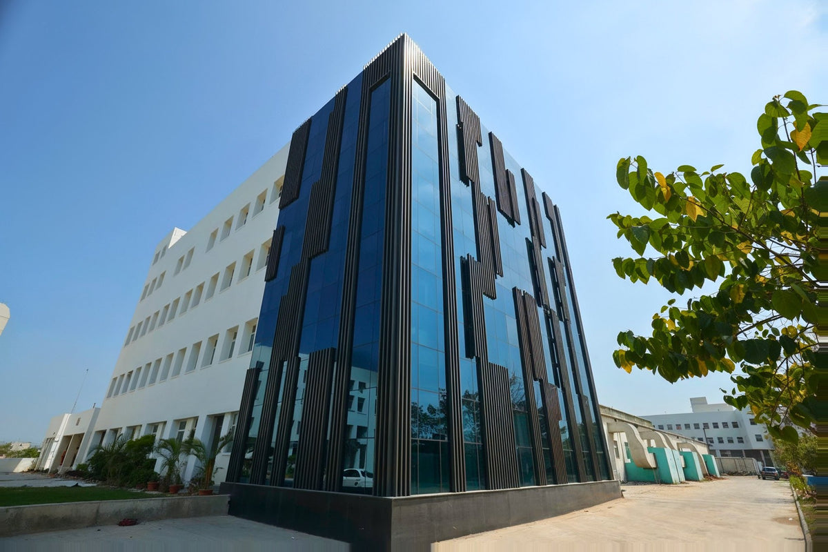 The AFPL Product Creation Centre, a dark glass facade