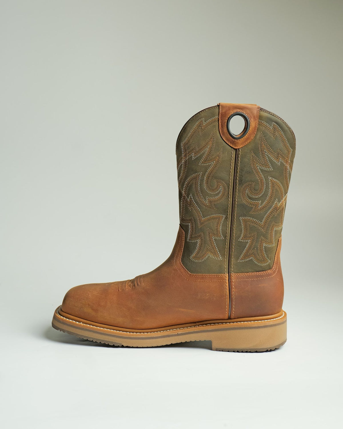 A pull-on work boot with an embroidered shaft