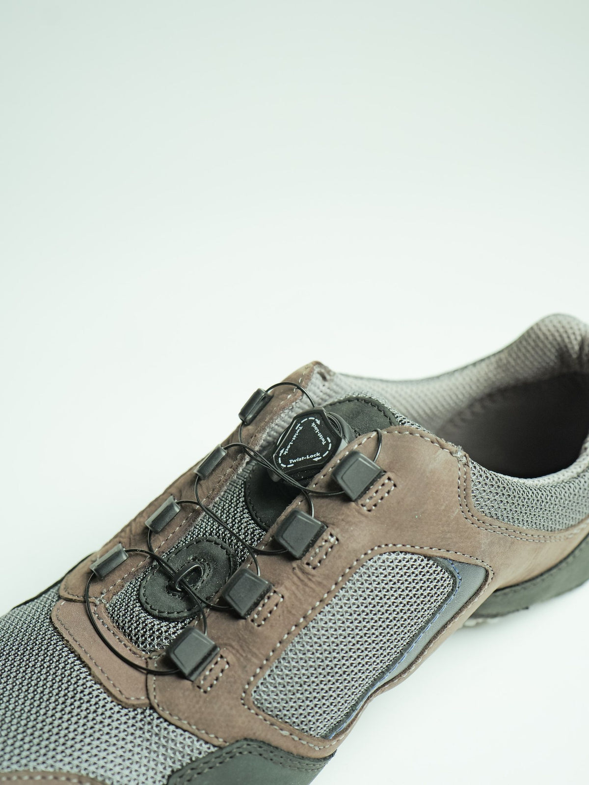 A suede and mesh shoe with a dial-operated auto-lacing closure, made by AFPL