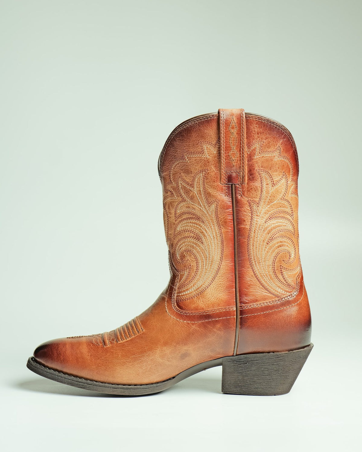 A tan women’s Western boot with a stitched shaft, made by AFPL