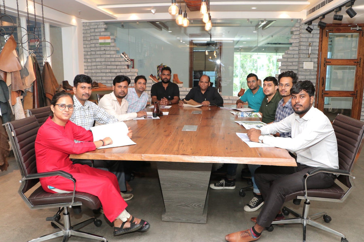 An AFPL team in discussion around the boardroom table