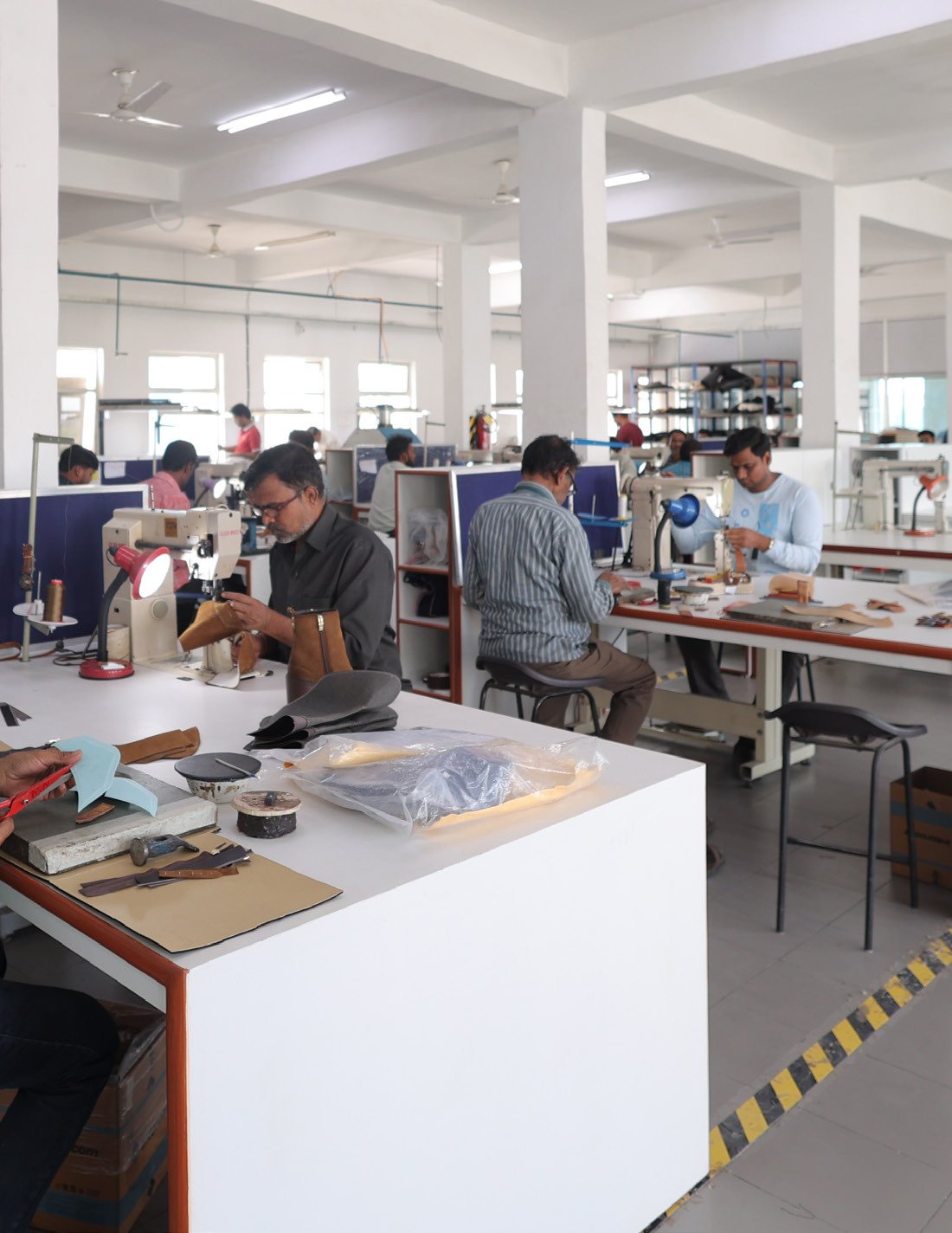 Teams at stitching machines in an AFPL training centre