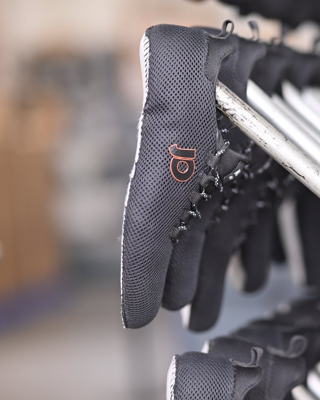 Uppers with their Strobel sock stitched all round, on the rack at AFPL