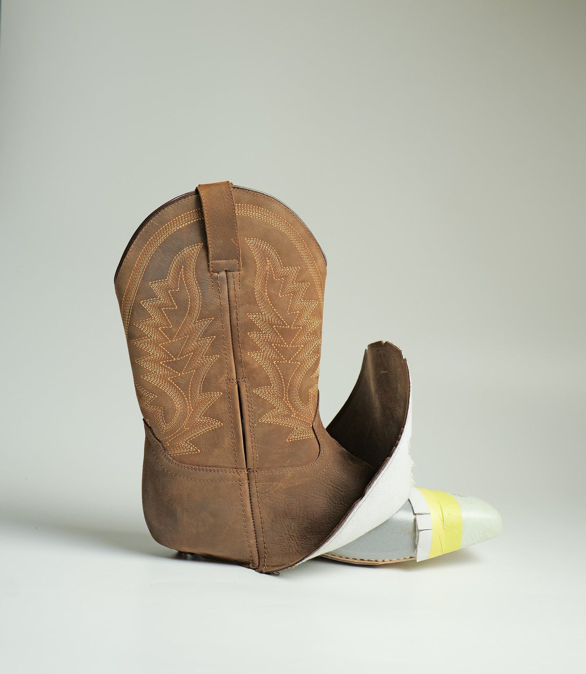 A Western work boot opened to show the bootie inside, made by AFPL