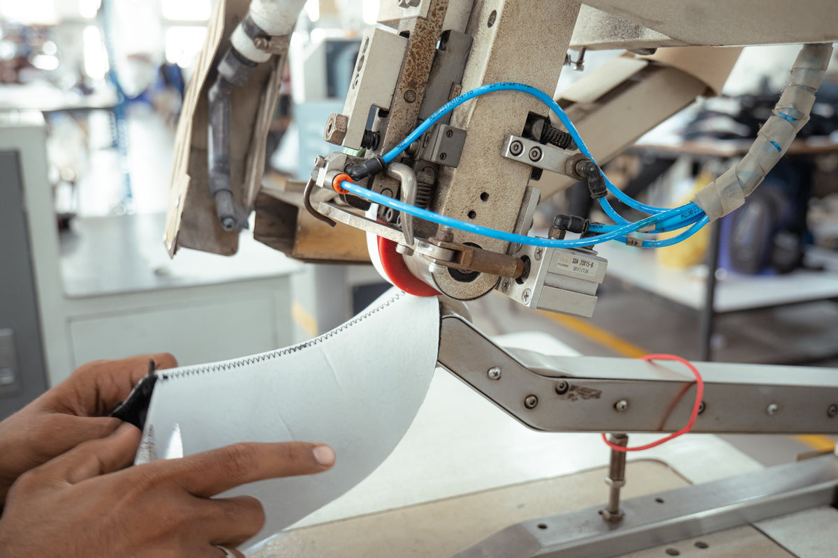 An upper guided through an automatic stitching machine