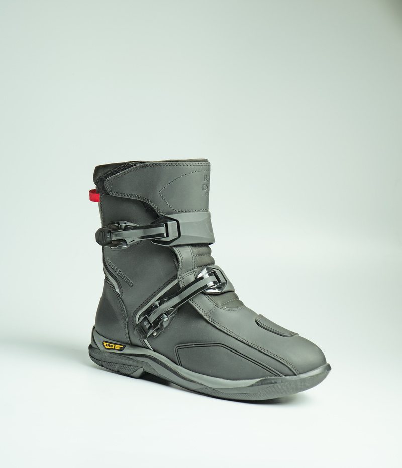 A black bike-riding boot with buckles and protective panels