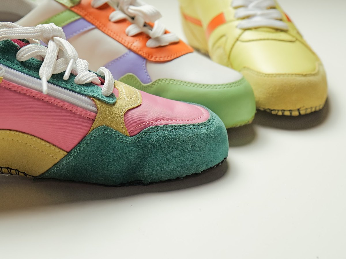 Close detail of closed sneaker uppers: panels, zips and stitching