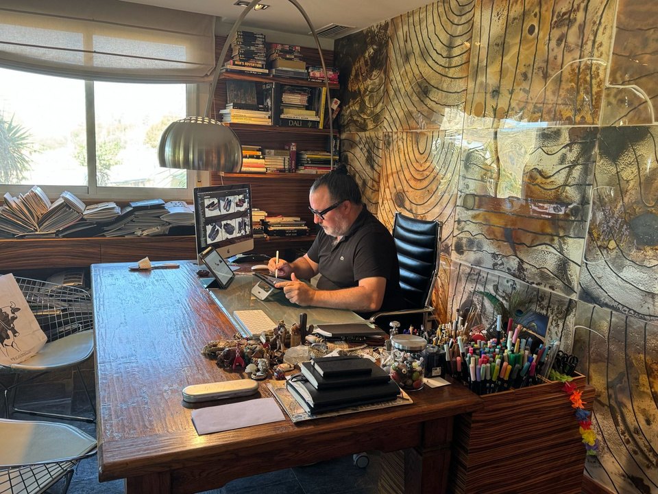 A designer sketching at his desk in the design studio in Spain