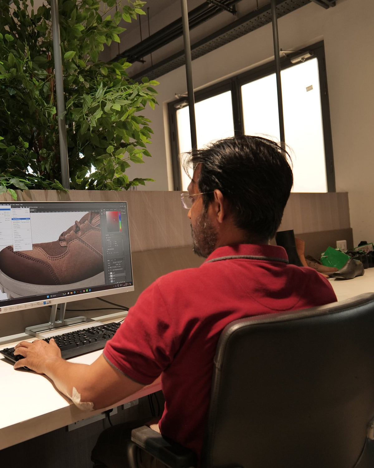 A developer reviewing a shoe model on screen in the AFPL Product Creation Centre