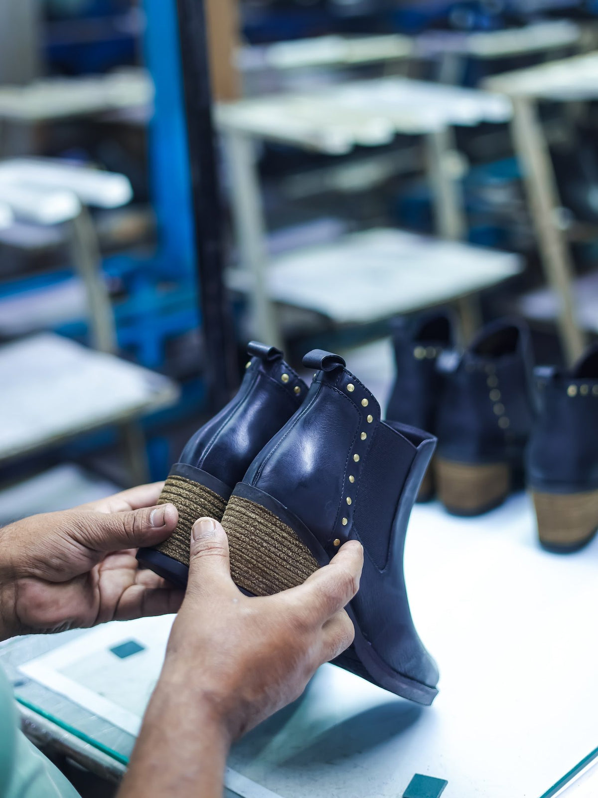 Finished ankle boots checked pair by pair before packing