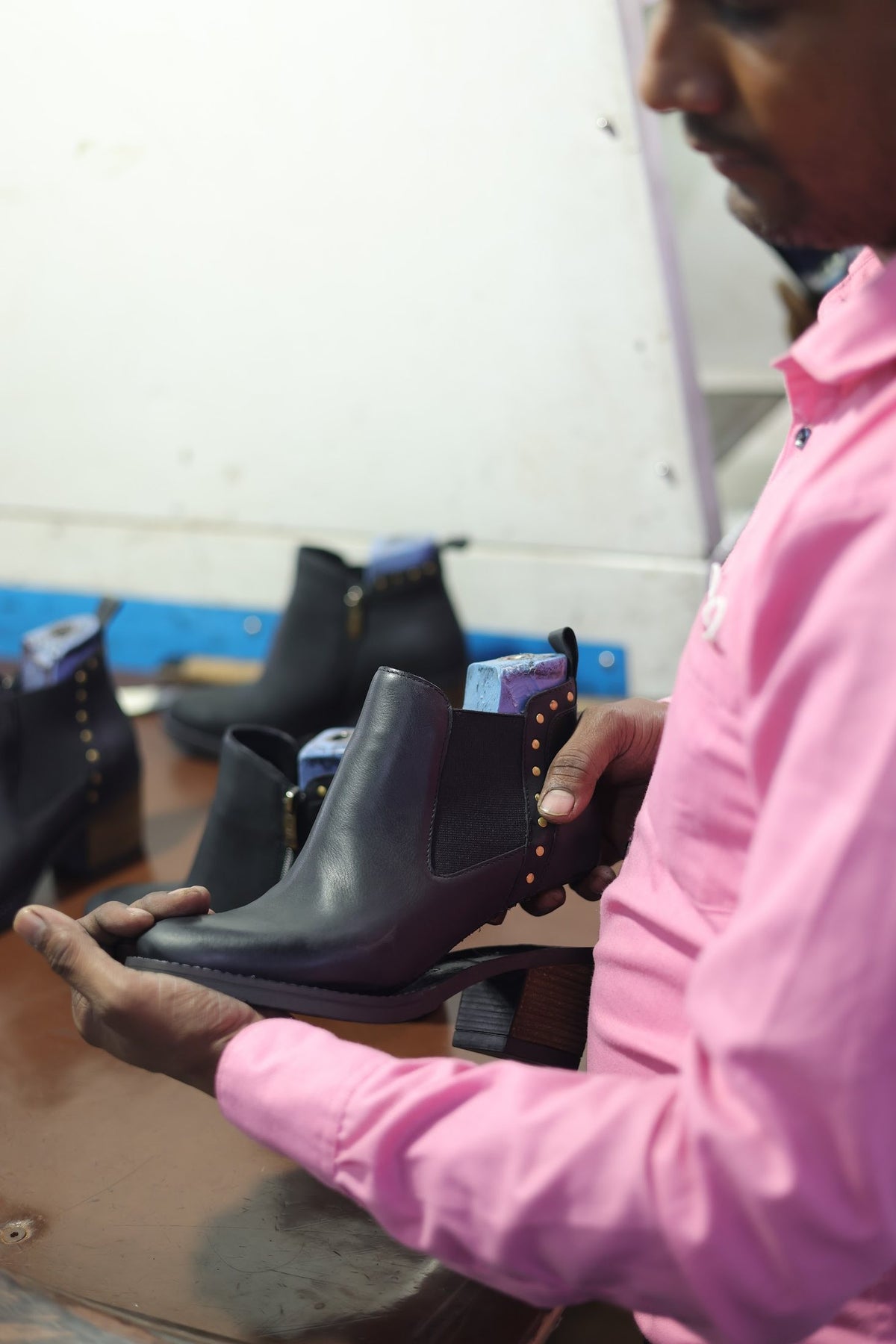 A finished pair of ankle boots checked before release
