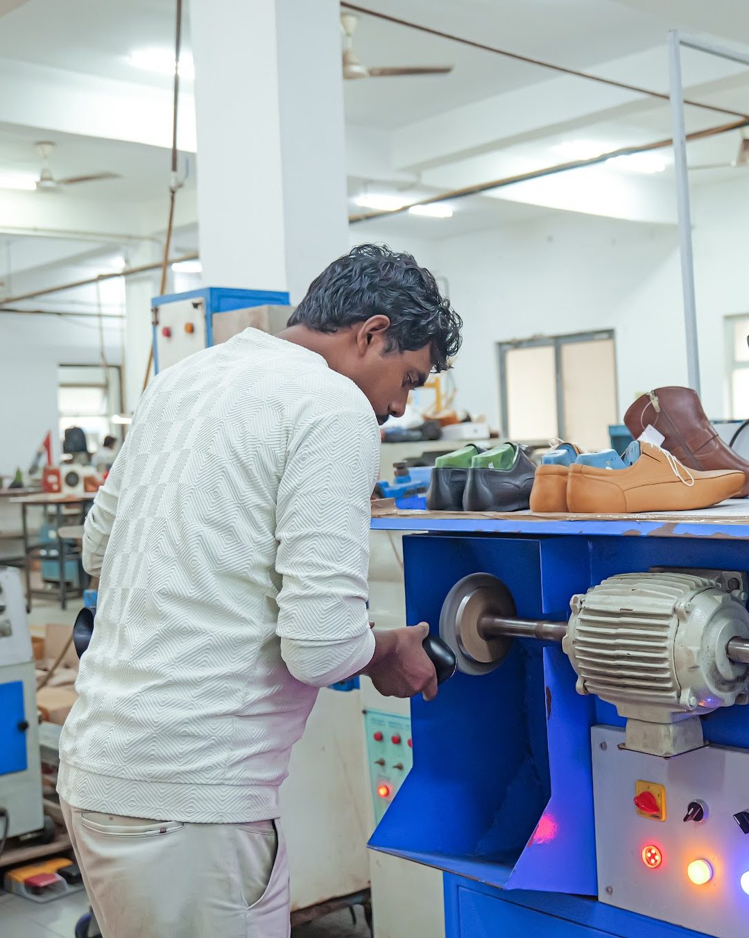 A finisher brushing footwear at a finishing machine