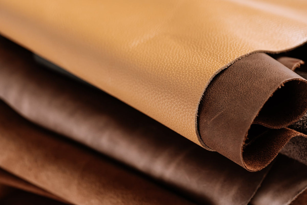 Folded hides of tan, brown and chocolate leather