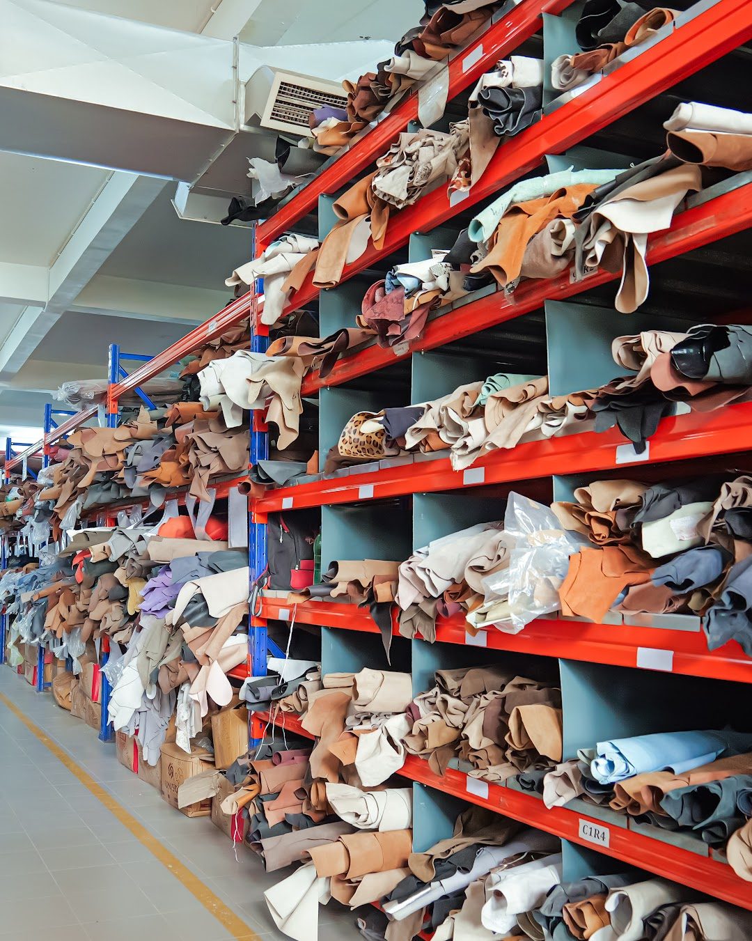 Hides on labelled racks in the AFPL leather store