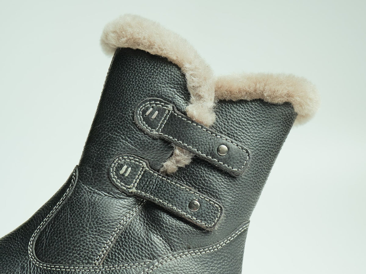 A lamb-fur lined leather boot with two straps