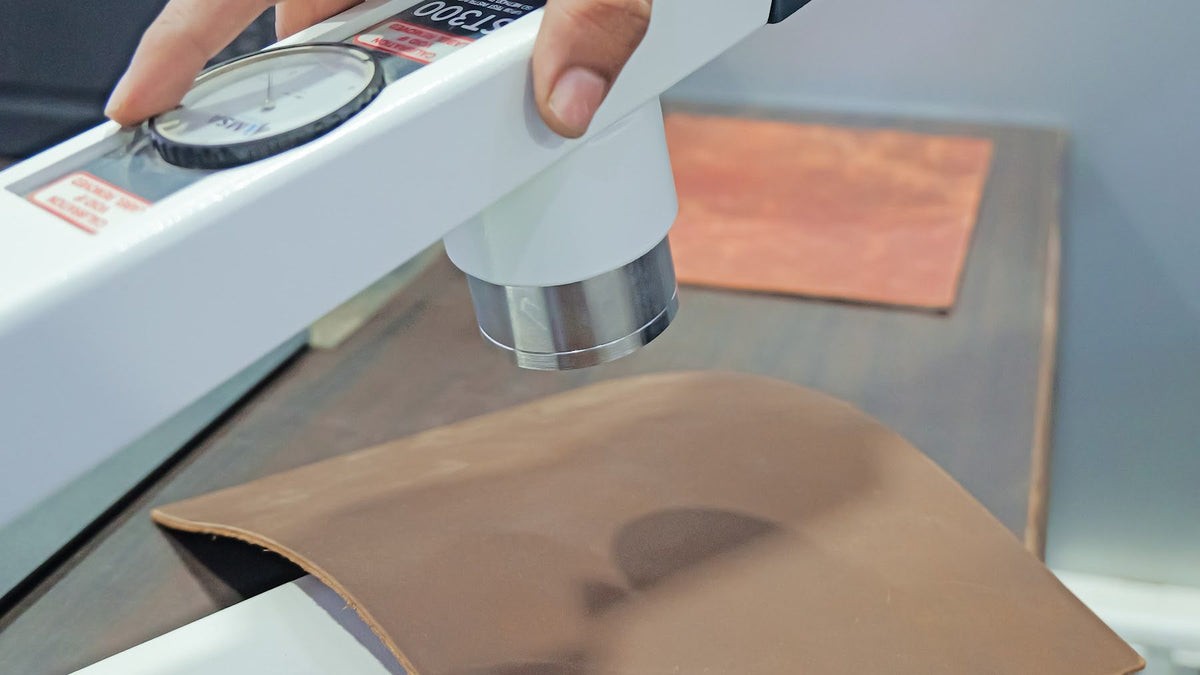 A leather sample under a laboratory tester