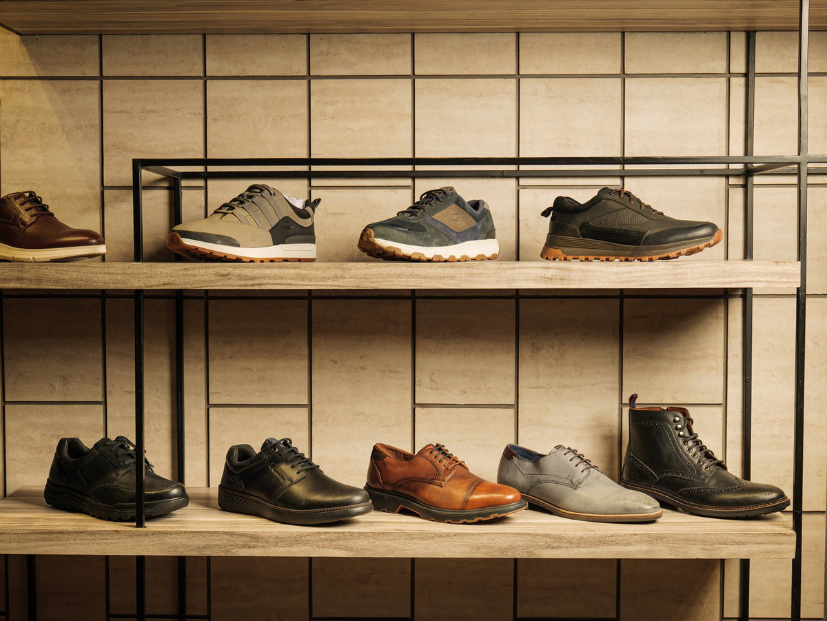 Men’s leather shoes and sneakers on a showroom shelf
