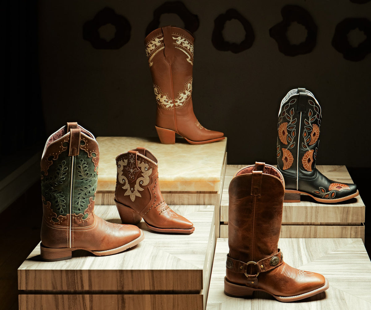 Men’s, women’s and youth cowboy boots on stone plinths