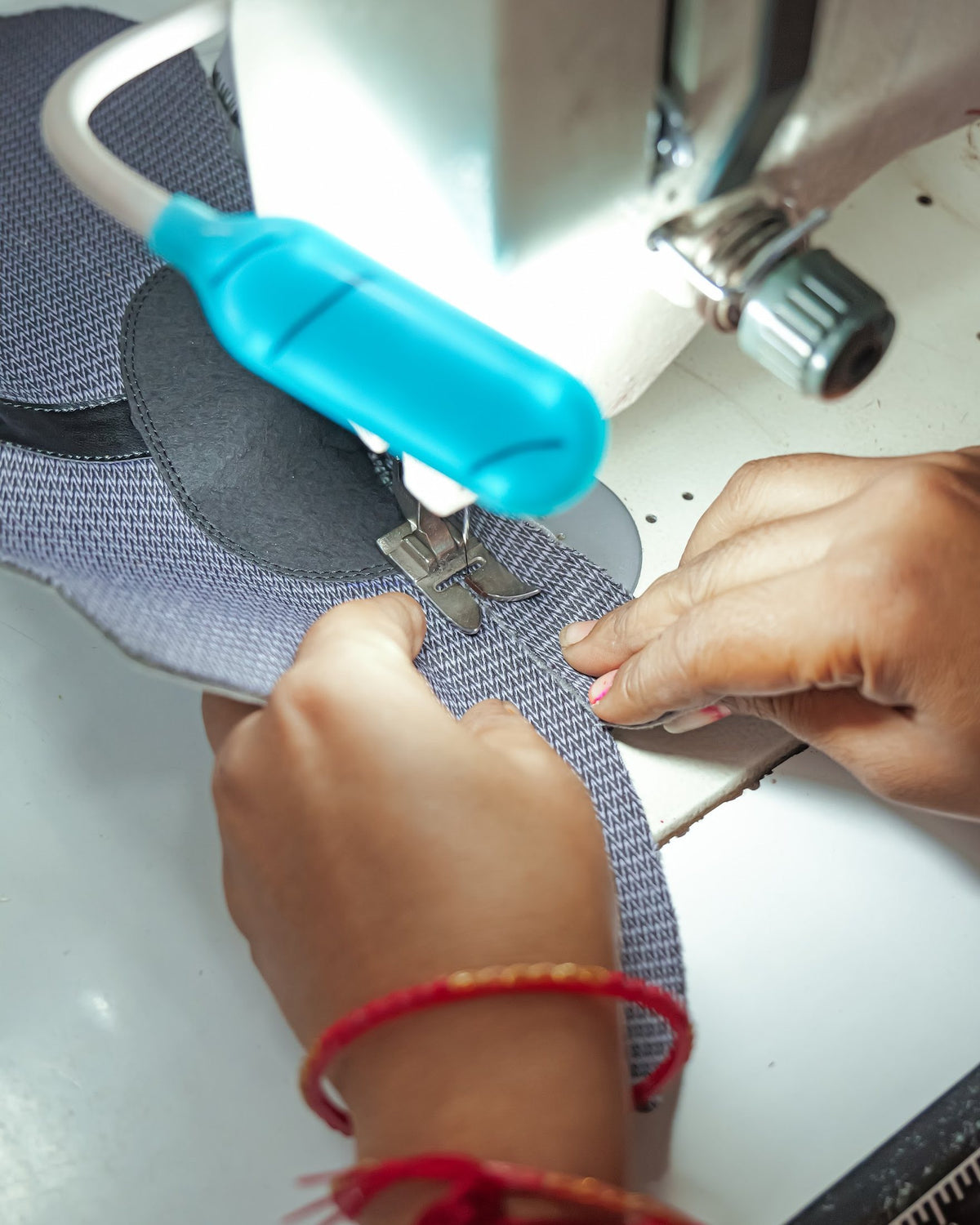 A mesh textile upper guided through a closing machine