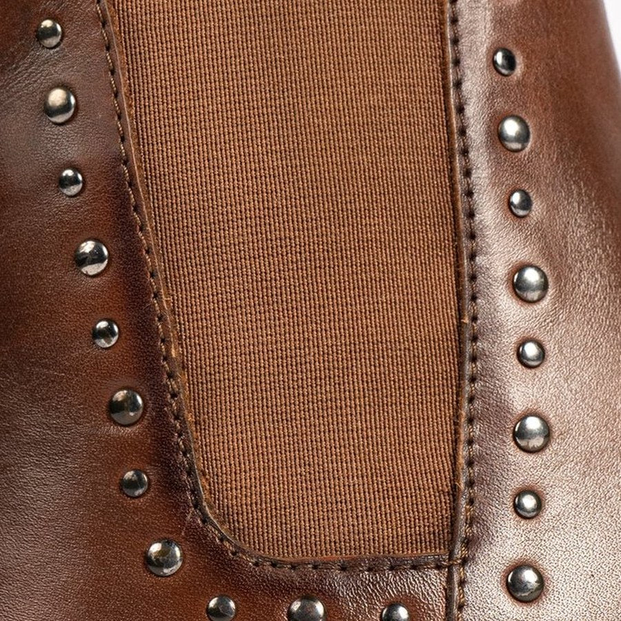 Metal studs on a leather boot