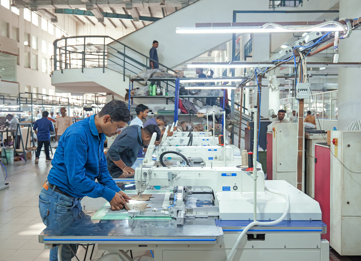 An operator at a row of automatic stitching machines
