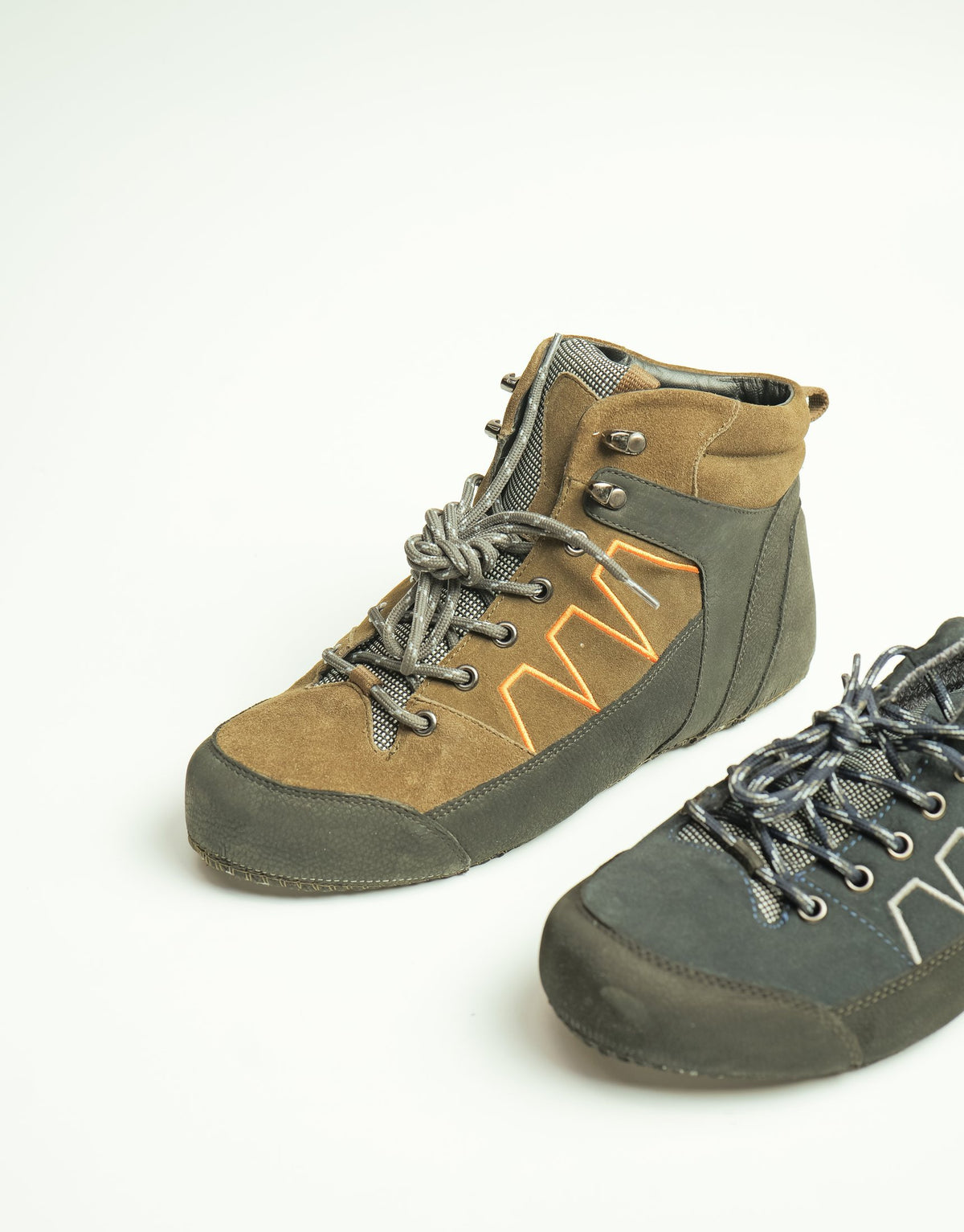 A pair of hiking-style uppers in tan and grey suede with contrast stitching