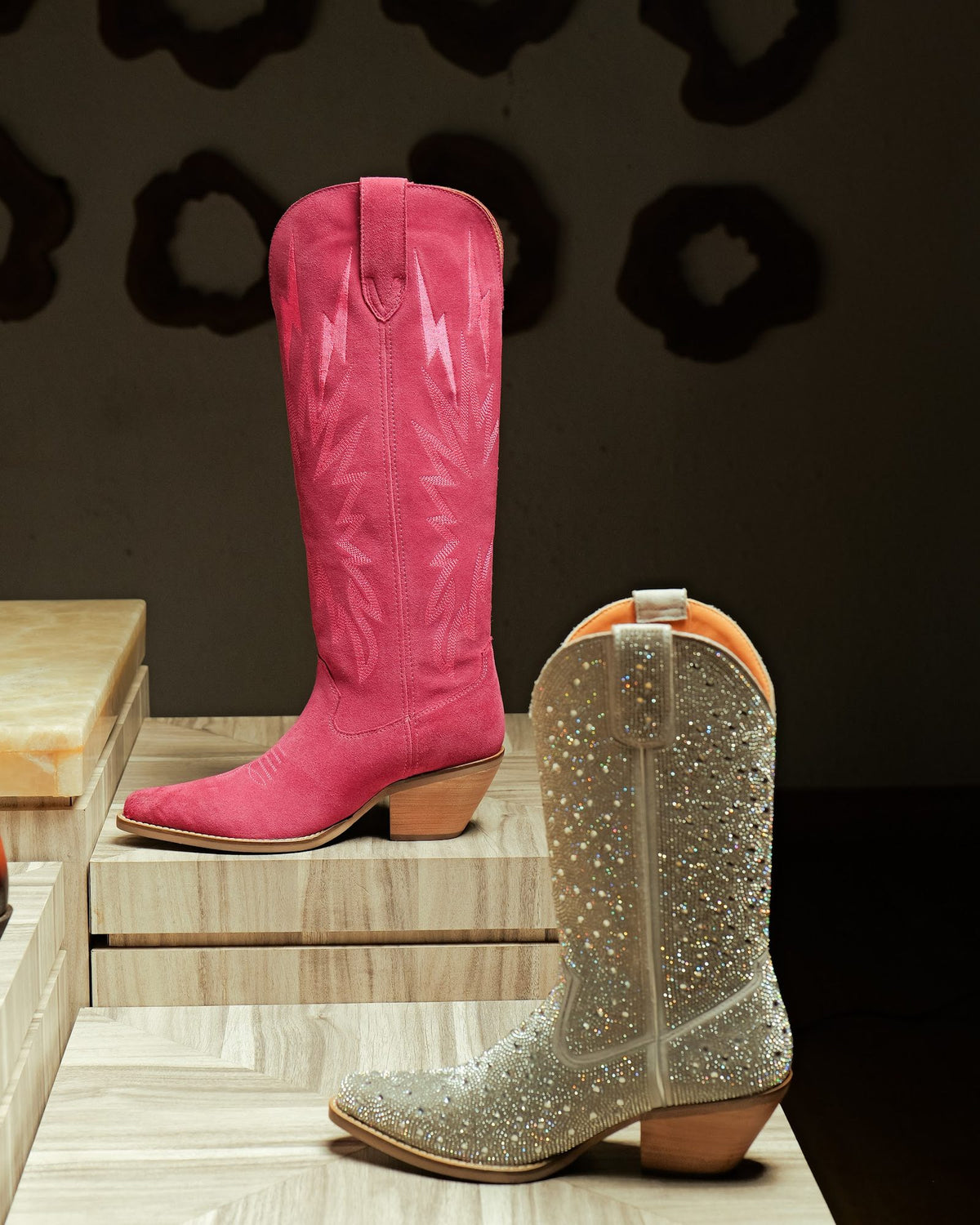 A pink suede women’s cowboy boot and a crystal-studded boot, Stuck-on construction
