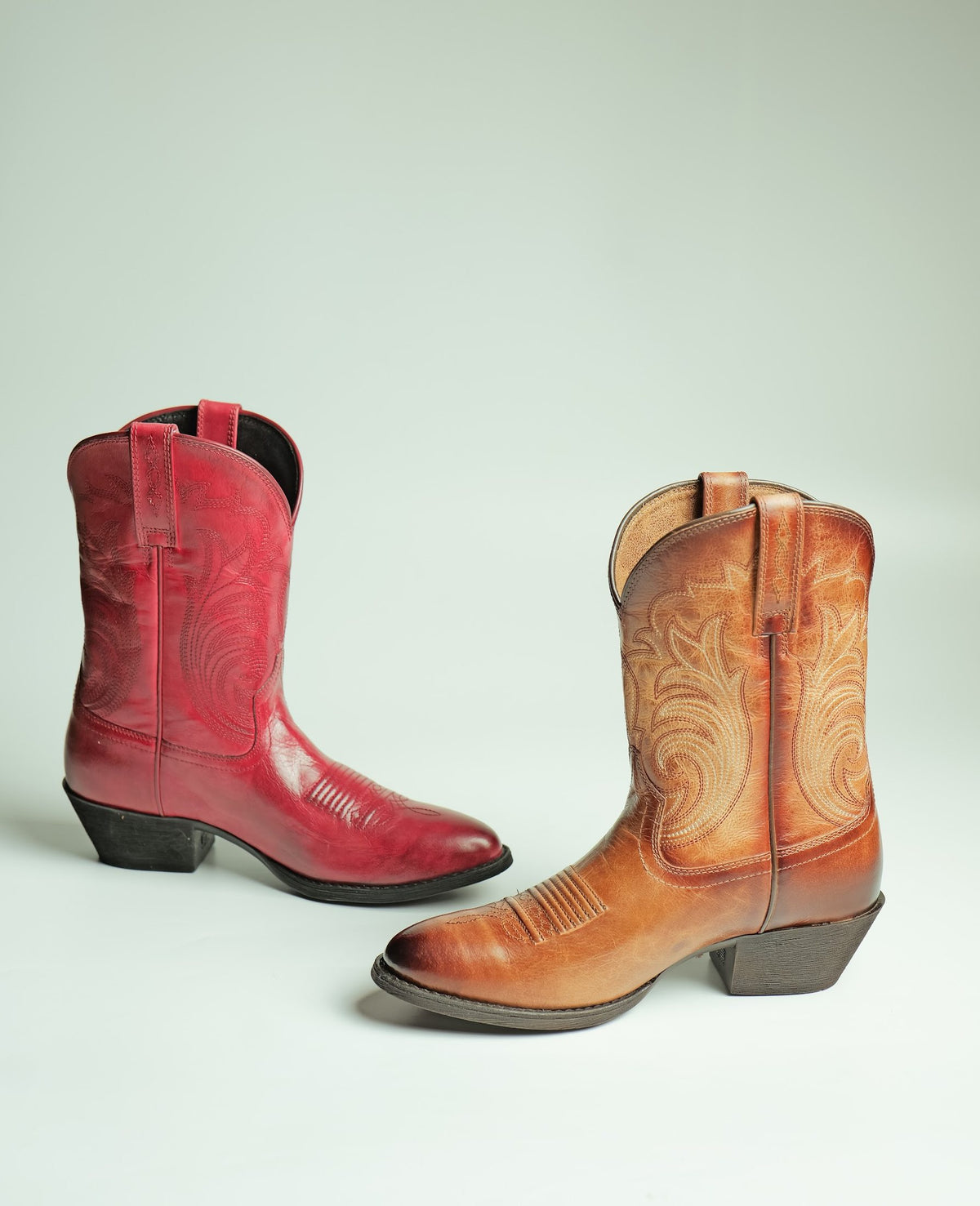 A red and a tan women’s Western boot