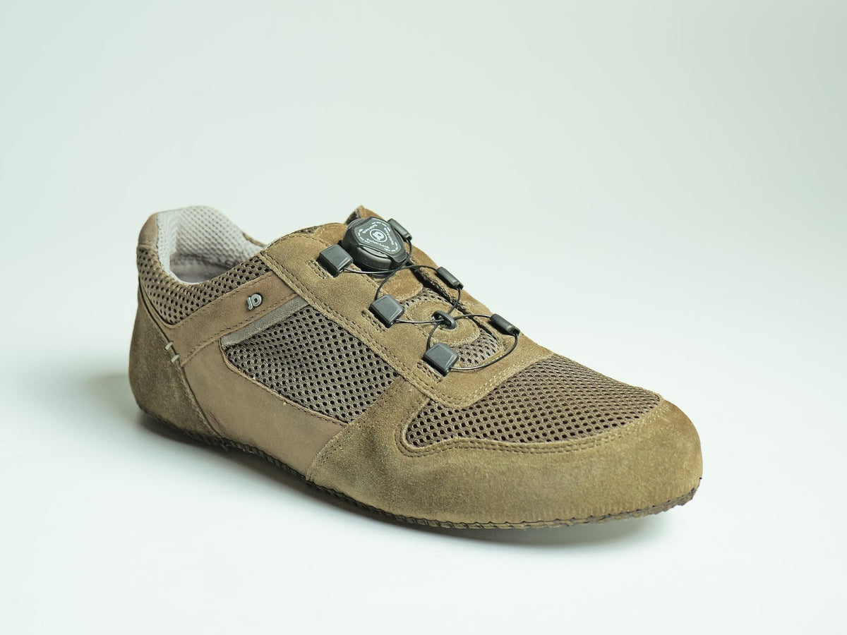 A suede shoe with a dial-operated auto-lacing closure, made by AFPL