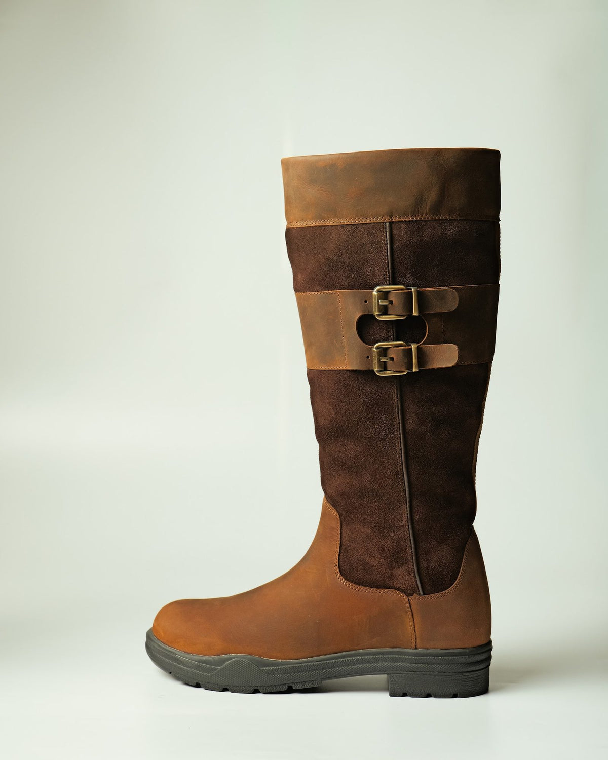 A tall buckled horse-riding boot