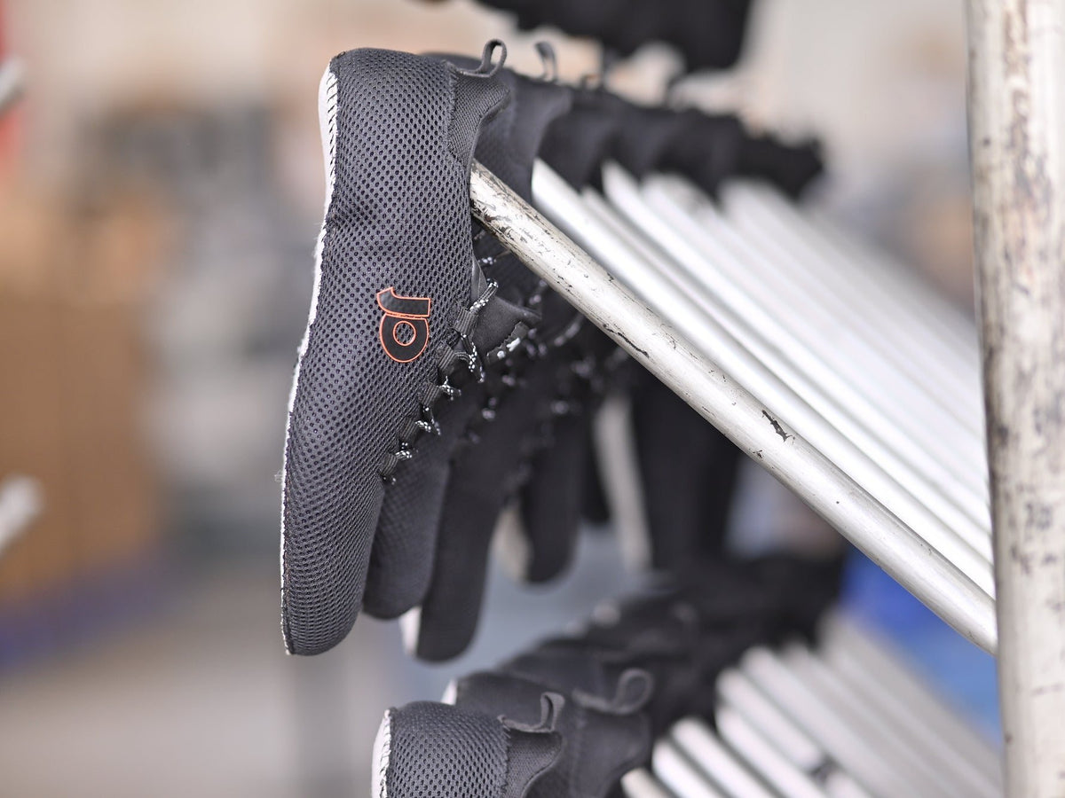 Uppers with their Strobel sock stitched all round, on the rack at AFPL