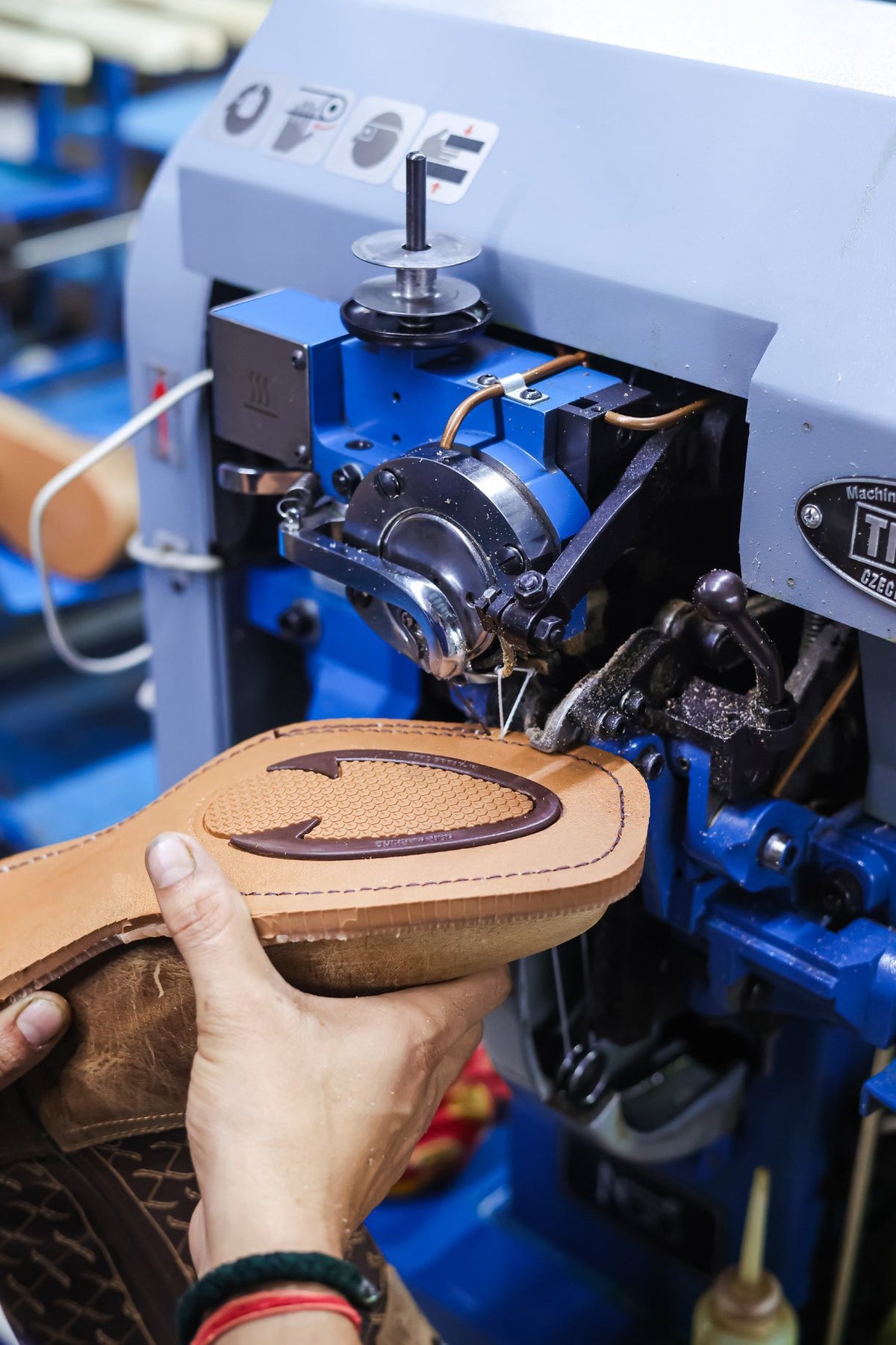A welted sole at a sole-stitching machine on the AFPL line
