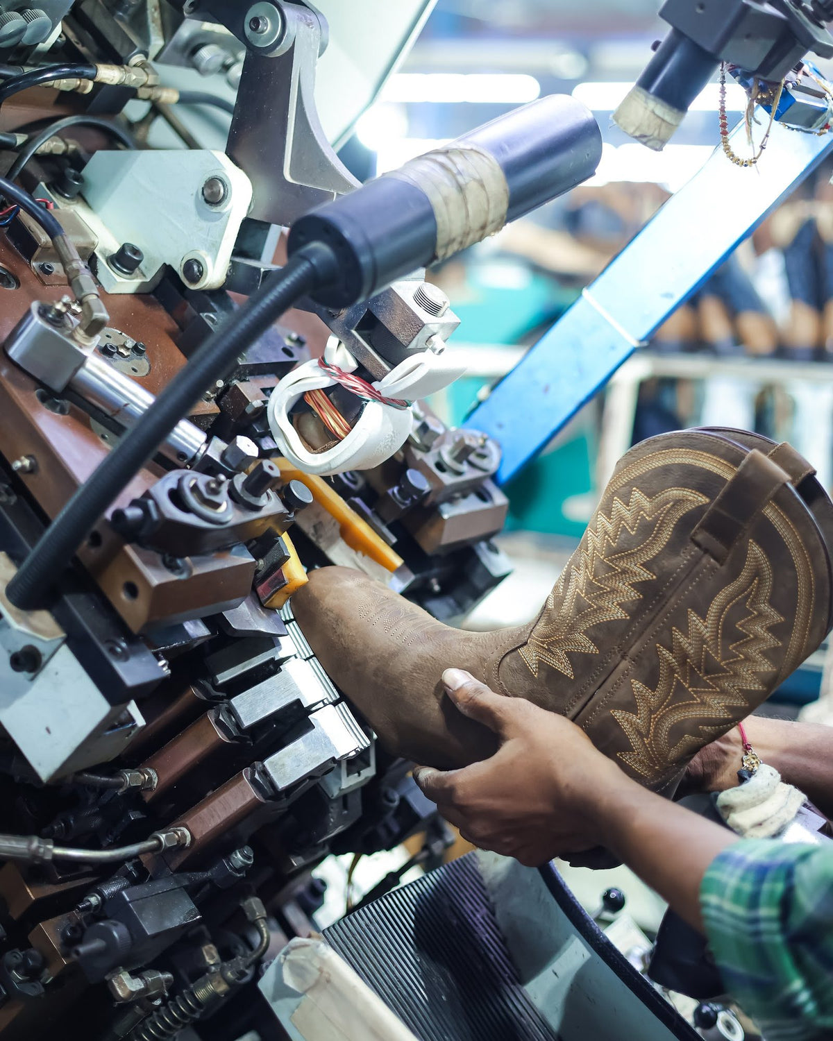A Western boot upper on a toe-lasting machine